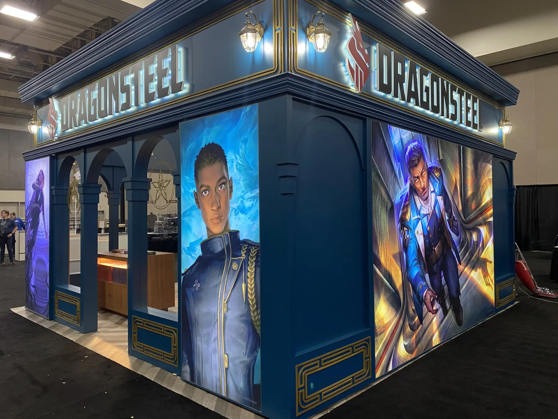 Dragonsteel exhibit corner showing two illustrated side panels and overhead branding